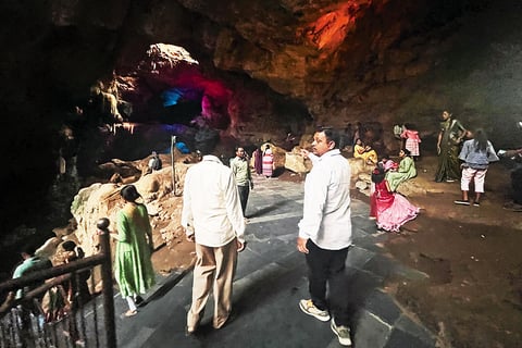 Tribal tourist guides showing people around Borra Caves in Andhra Pradesh