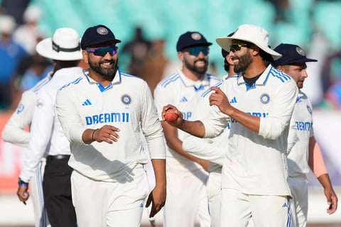 India's captain Rohit Sharma, left, and teammate Ravindra Jadeja celebrate after India won the third cricket test match against England in Rajkot, India, Sunday, Feb. 18, 2024.