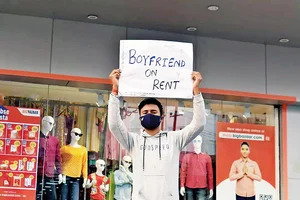 Photo: Priyanshu : Not So Subtle: A person holds a placard suggesting he is available on rent