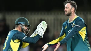 X/ICC : Matthew Wade (L) and Glenn Maxwell celebrate Rovman Powell's wicket during the 1st T20I between Australia and West Indies in Hobart.