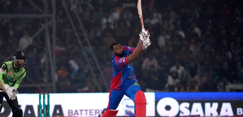 AP : Karachi Kings' Kieron Pollard plays a shot as Lahore Qalandars' Shai Hope watches during their Pakistan Super League cricket match in Lahore, February. 24, 2024.