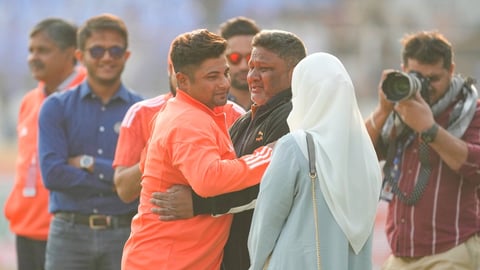 Sarfaraz Khan, third left, is greeted by his father as he prepares to play his first Test during the India vs England match in Rajkot on February 15, 2024.