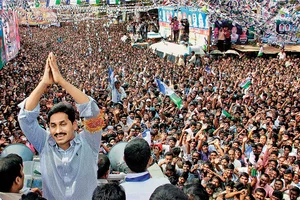 Photo: PTI : Father and Son Jagan Mohan Reddy at a public meeting