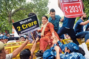 Photo: Getty Images : Grave Issues: Police detain an activist during a protest against the government over rising inflation and unemployment  