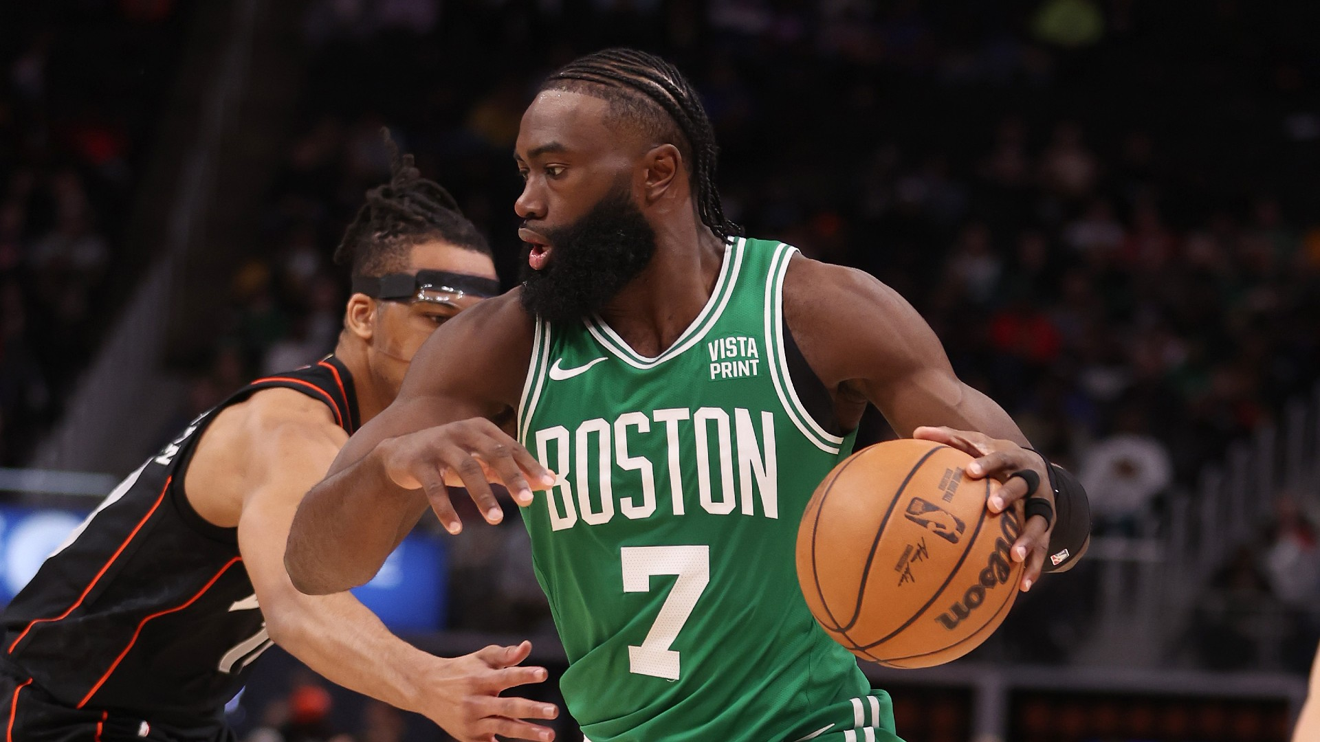 Jaylen Brown #7 of the Boston Celtics drives around Tosan Evbuomwan #18 of the Detroit Pistons during the first half at Little Caesars Arena on March 22, 2024