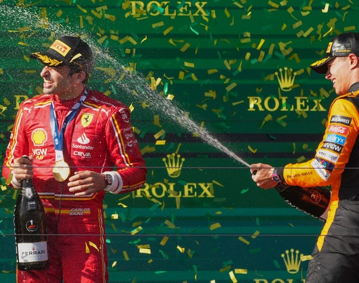 Photo: AP/Scott Barbour : Ferrari driver Carlos Sainz of Spain is sprayed in champagne after winning the Formula 1 Australian Grand Prix by McLaren driver Lando Norris, right, of Britain at Albert Park, in Melbourne.