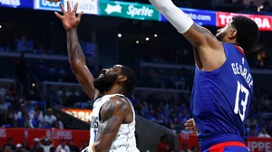 Paul George of the Los Angeles Clippers (right) defends a shot by Dallas Mavericks guard Kyrie Irving on April 21, 2024.