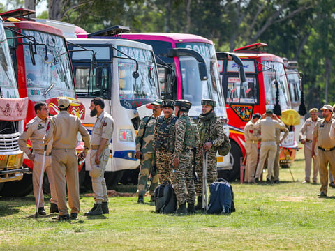 Security personnel wait to leave for election duty ahead of the 2nd phase of voting for Lok Sabha elections, in Jammu, Thursday, April 25, 2024.