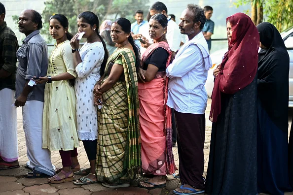 People queue to cast their vote at a polling station during the second phase of voting of India's general elections in Wayanad district in Kerala on April 26, 2024. - (Photo by R. SATISH BABU via Getty Images)