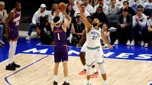 Rudy Gobert attempts to block a shot from Devin Booker.
