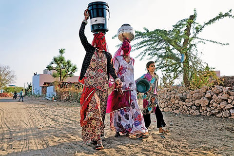 Women from Rotoo village going back after filling water from the underground tank