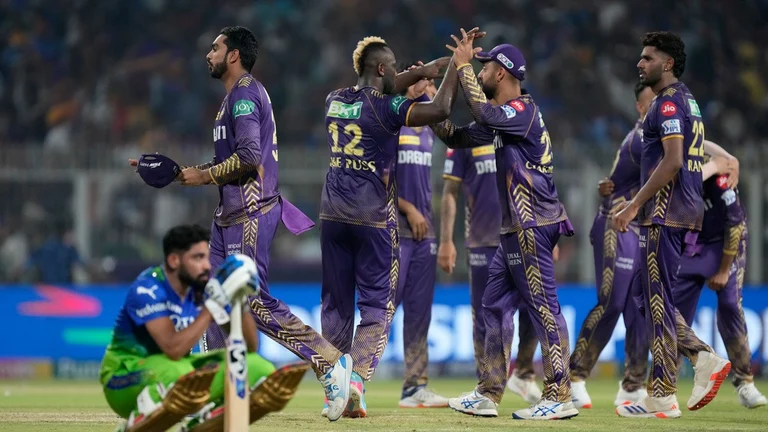 Royal Challengers Bengaluru's Mohammed Siraj sits dejected as Kolkata Knight Riders celebrate their win in match 36 of Indian Premier League 2024 at Eden Gardens. - AP/Bikas Das