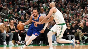 File : Jalen Brunson #11 of the New York Knicks drives to the basket against Derrick White #9 of the Boston Celtics during the second quarter at the TD Garden on April 11, 2024
