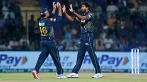 AP : Gujarat Titans' Sandeep Warrier, right, and teammate Rahul Tewatia celebrate the wicket of Delhi Capitals' player.