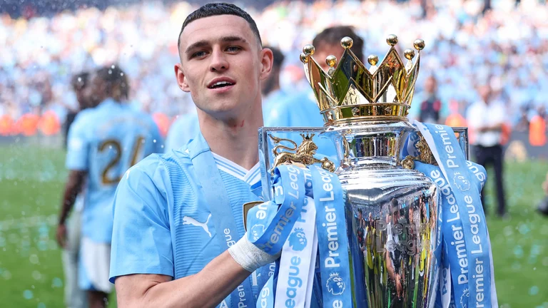 Phil Foden poses with the Premier League trophy after winning his sixth title - null