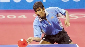 Photo: X/ @sharathkamal1 : Sharath Kamal playing table tennis in the Athens Olympics in 2004.
