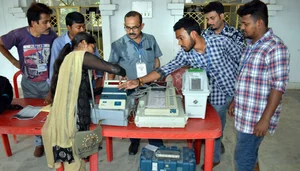 PTI : Officials at a polling booth during Lok Sabha elections |