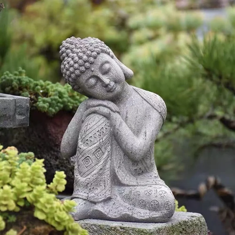 A serene Buddha statue seated on a rock, radiating tranquility and wisdom.