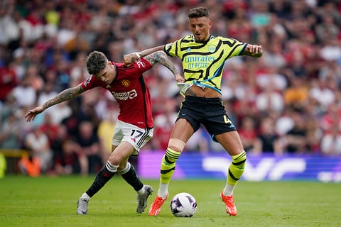 Alejandro Garnacho challenges for the ball with Ben White