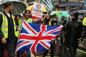 Getty Images : Protesters march to the Indian High Commission behind a union flag saying Stand With Kashmir on August 5, 2023 in London. The Kashmiri community and their supporters gather to protest at the imprisonment of Yasin Malik, the leader of the Jammu Kashmir Liberation Front (JKLF) 