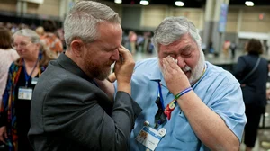 AP : Rev. Andy Oliver, Pastor of Allendale UMC in St. Petersburg, Florida, left, and David Meredith wipe away tears after an approval vote at the United Methodist Church General Conference on May 1, 2024.