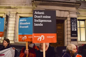 Getty Images : Demonstrators hold 'Save Hasdeo Forest' and 'Adani: Don't Mine Indigenous Lands' placards during protest