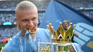 Erling Haaland celebrates with the Premier League trophy on Sunday.