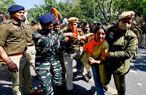 Getty Images : ABVP activists being detained by security personnel during protest against Mamata Banerjee government over Sandeshkhali case.