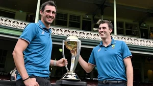 Photo: X/ @dilbag_koundal : Australian cricketers Mitchell Starc (L) and Pat Cummins with 50-over World Cup trophy.