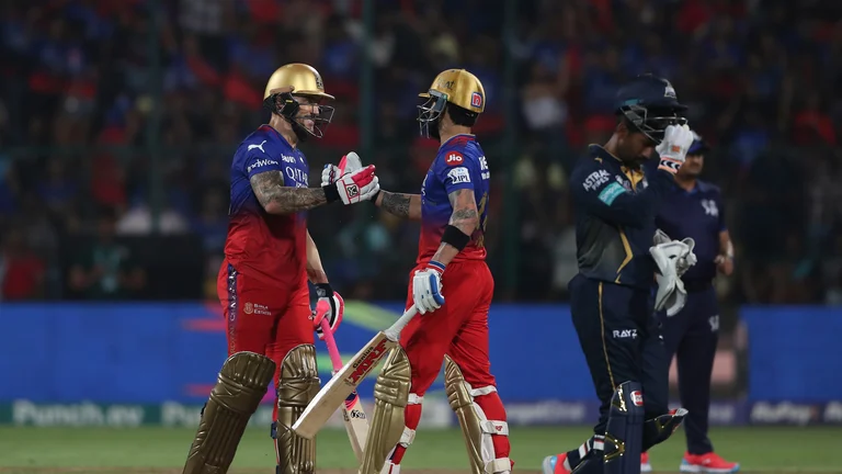 Royal Challengers Bengaluru's Virat Kohli congratulates captain Faf du Plessis on scoring 50 runs during the Indian Premier League cricket match between Royal Challengers Bengaluru and Gujarat Titans in Bengaluru. - AP Photo