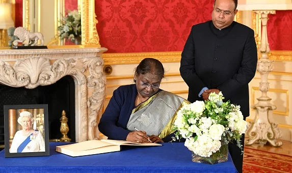 President Droupadi Murmu signing a book of condolence for Queen Elizabeth II at Lancaster House on Sep 18, 2022 in London. - WPA Pool/Getty Images