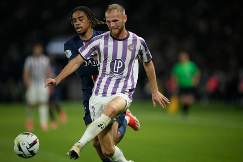 Mikkel Desler is challenged by PSG's Bradley Barcola