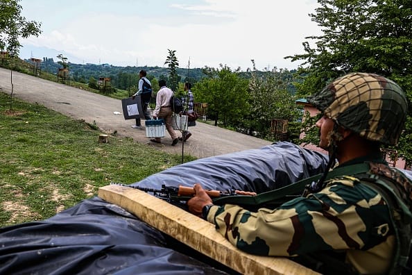 Polling officers are carrying Electronic Voting Machines (EVM) and Voter Verifiable Paper Audit Trail (VVPAT) machines as they are moving towards their respective polling stations amid tight security ahead of the fifth phase voting of the Lok Sabha elections in Baramulla, Jammu and Kashmir, India, on May 19, 2024.  - (Photo by Nasir Kachroo/NurPhoto via Getty Images)