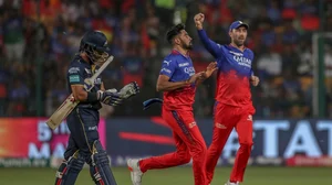AP Photo  : Royal Challengers Bengaluru's Mohammed Siraj, center, and Maxwell celebrates the dismissal of Gujarat Titans' Wriddhiman Saha, left, during the Indian Premier League cricket match between Royal Challengers Bengaluru and Gujarat Titans in Bengaluru, India, Saturday, May 4, 2024. 