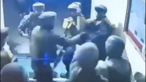 X : Screengrab of the cops vs army soldiers tussle from the purported video.