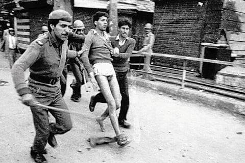 A man being detained in Srinagar in 1985