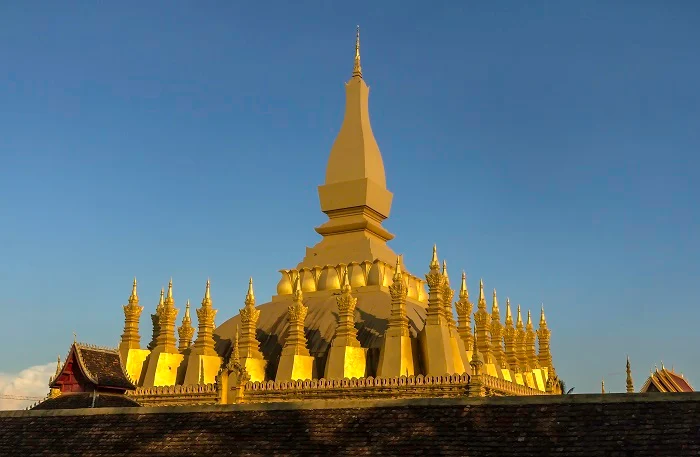 Shimmering golden spires of Pha That Luang temple.