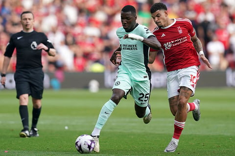 Caicedo and Morgan Gibbs-White challenge for the ball