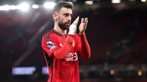 Bruno Fernandes applauds the fans at Old Trafford.