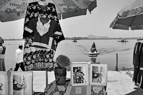 A shop displays Kashmiri traditional attire on the banks of Dal Lake