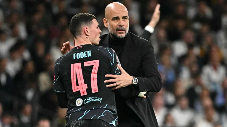 Foden and Guardiola embrace - null