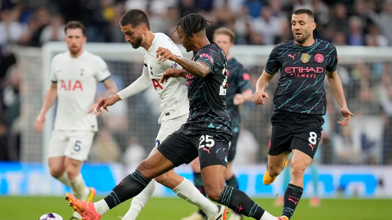 Tottenham's Rodrigo Bentancur, second left, and Manchester City's Manuel Akanji challenge for the ball during the English Premier League soccer match. - AP