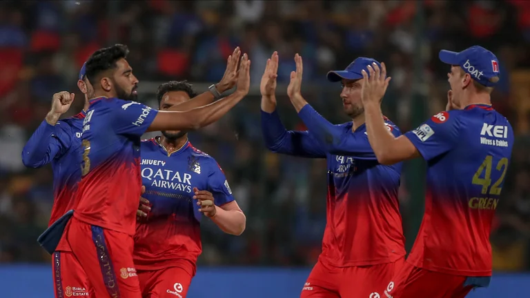 Royal Challengers Bengaluru's Mohammed Siraj, left without cap, celebrates with teammates after the dismissal of Gujarat Titans' Wriddhiman Saha during the Indian Premier League cricket match between Royal Challengers Bengaluru and Gujarat Titans in Bengaluru. - AP Photo