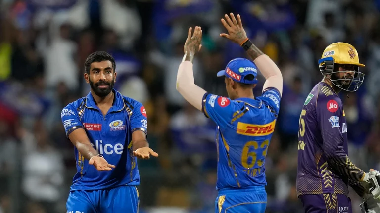 Mumbai Indians' Jasprit Bumrah celebrates the wicket of Kolkata Knight Riders' Mitchell Starc during the Indian Premier League cricket match between Mumbai Indians and Kolkata Knight Riders in Mumbai. - AP Photo/Rajanish Kakade