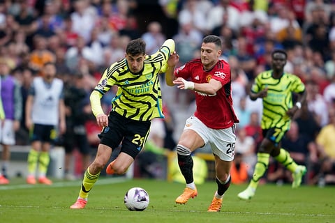 Kai Havertz, left, challenges for the ball with Diogo Dalot 