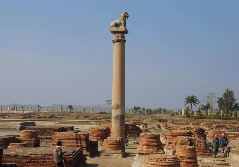 A majestic lion perched atop a grand column, part of the iconic pillars of Ashoka. A symbol of strength and power.