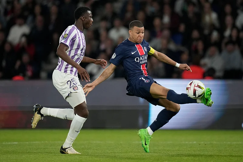 Kylian Mbappe challenged by Toulouses Kevin Keben 