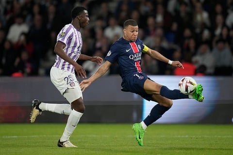 Kylian Mbappe challenged by Toulouse's Kevin Keben 