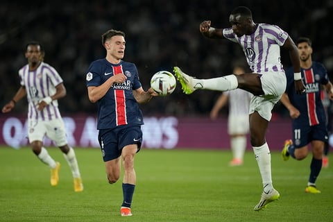 Moussa Diarra is challenged by PSG's Manuel Ugarte