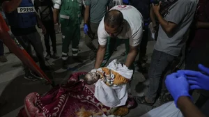 AP : A medic in the image moves a child killed in Israeli airstrike |